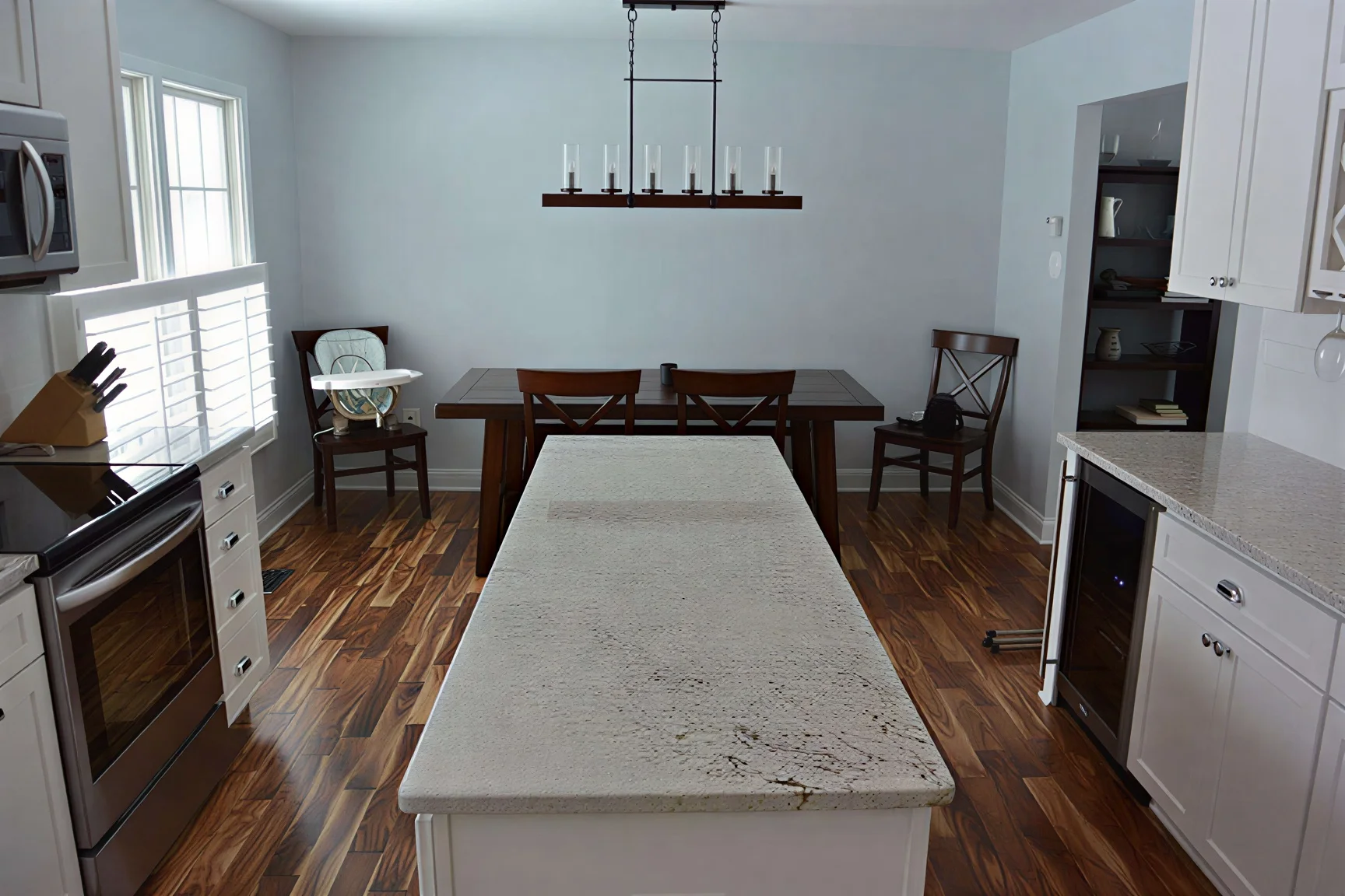 Projects modern kitchen and dining room with island and hardwood floors