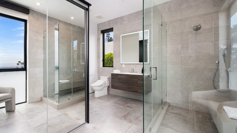 A Frameless Shower Door Needs a Wall Built for It